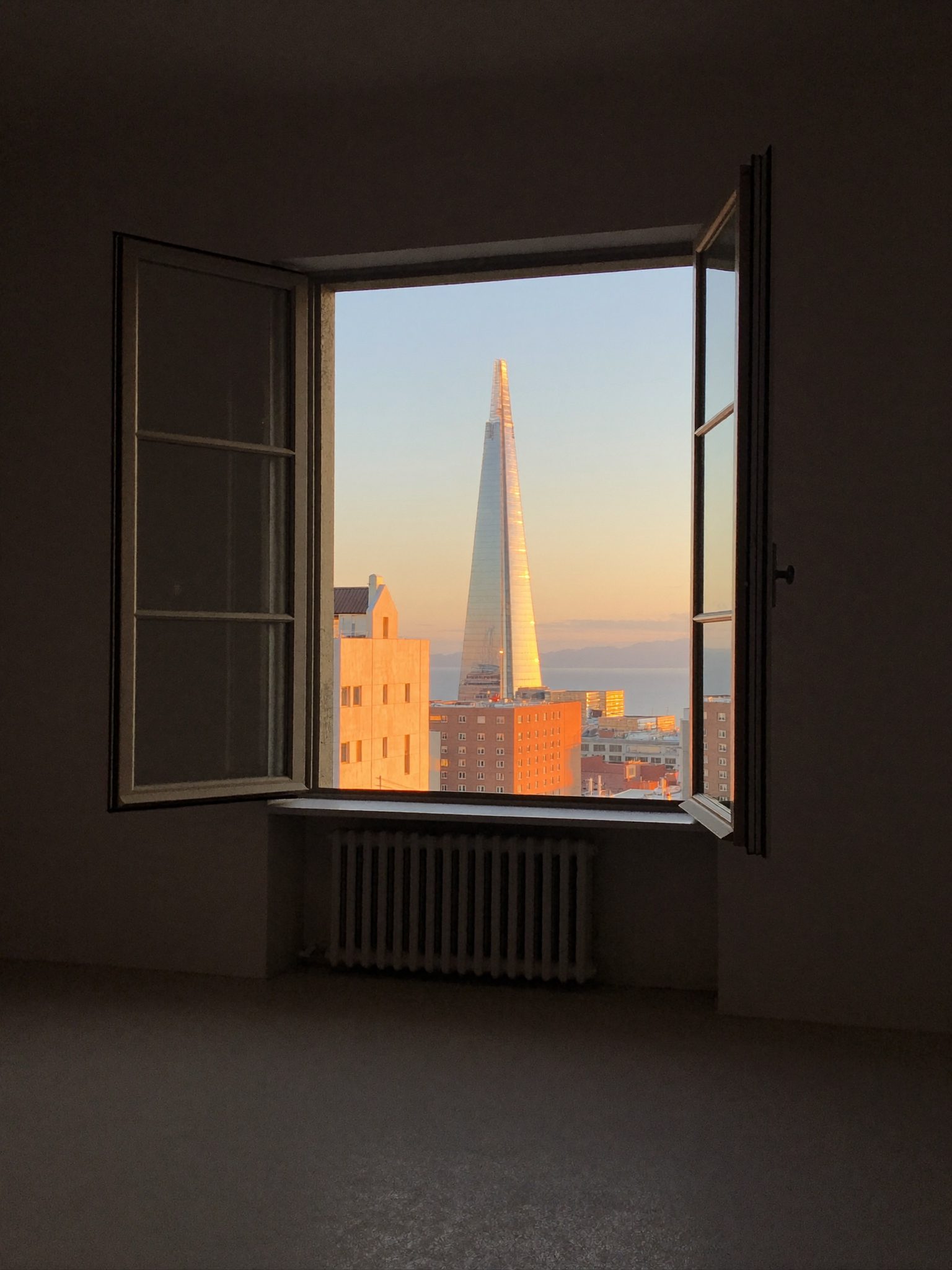 Coastal light falling through an upstairs window over the Quigney rooftops