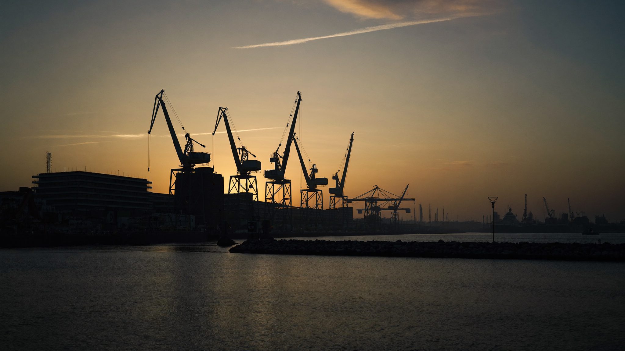 Buffalo City harbour in East London at first light, boats moored under a warm sunrise